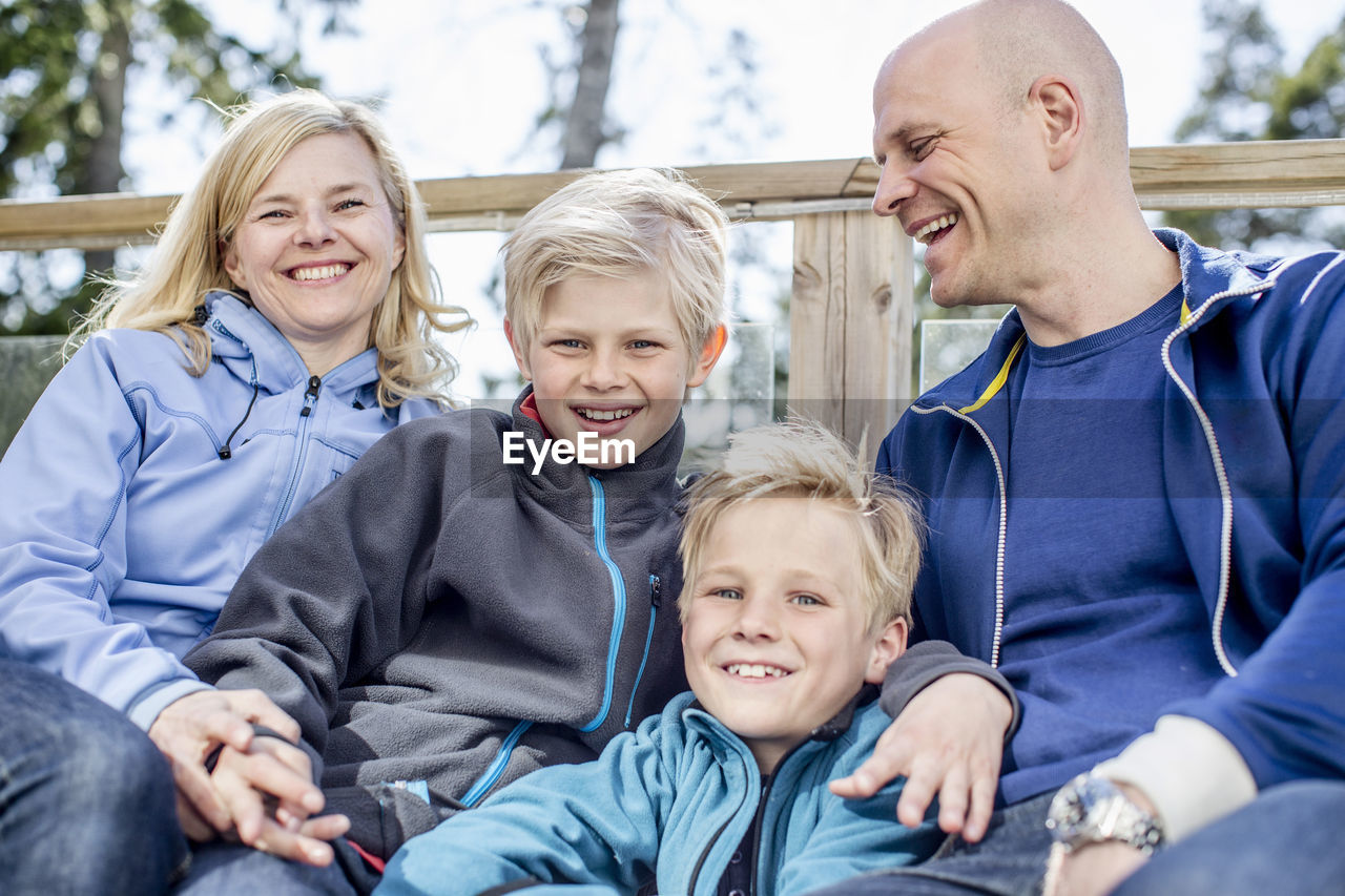 Portrait of happy boys with mother and father outdoors