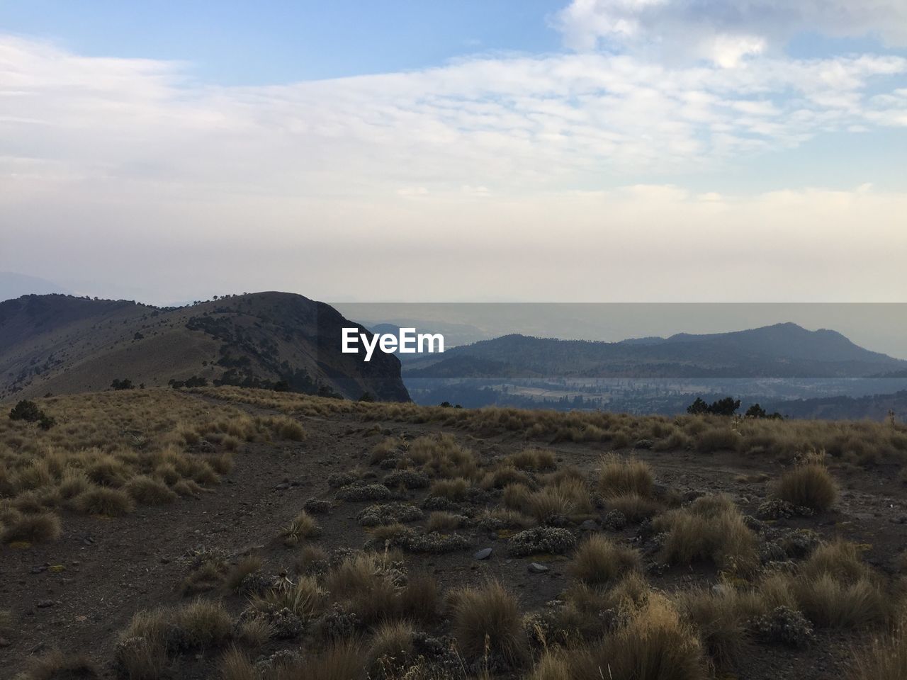 Scenic view of landscape and mountains against sky