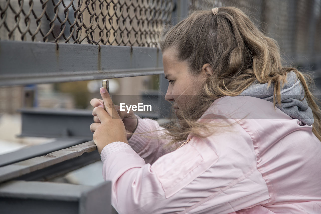 Side view of woman using mobile phone