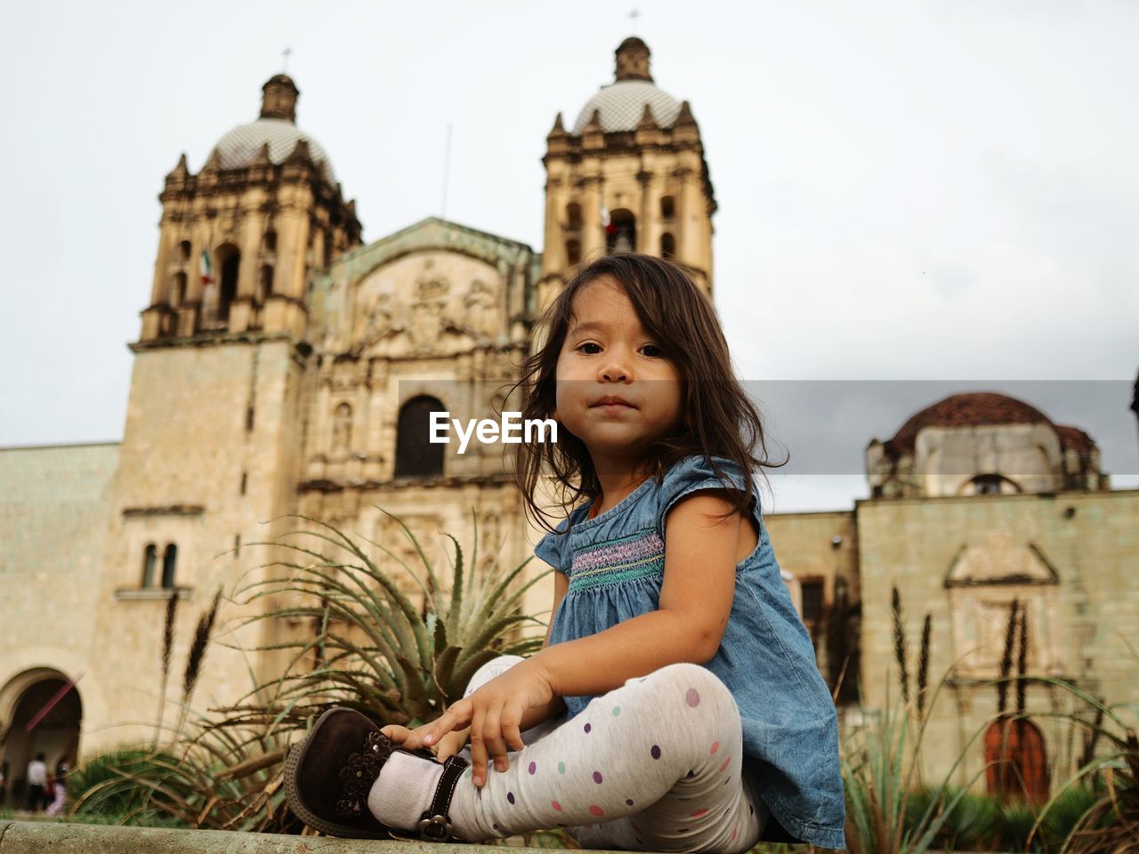 Low angle view of girl sitting at church