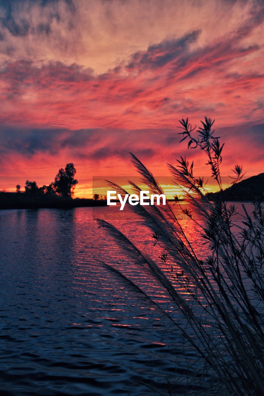 SCENIC VIEW OF LAKE AGAINST ROMANTIC SKY