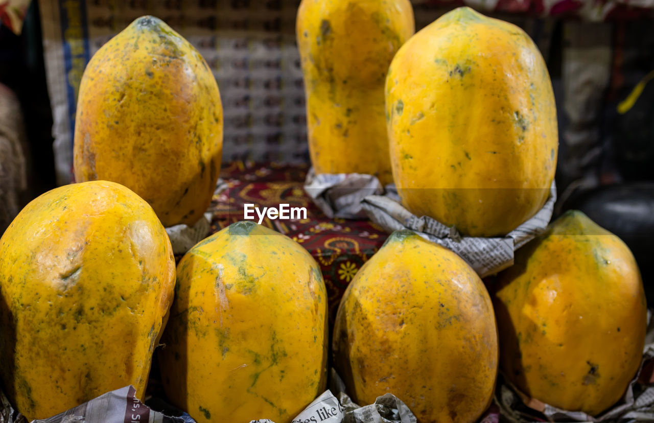 food, food and drink, fruit, healthy eating, yellow, plant, produce, freshness, market, wellbeing, mango, market stall, tropical fruit, no people, retail, mango fruit, close-up, for sale, outdoors, gourd, autumn, abundance, business finance and industry, group of objects, container, citrus fruit, still life