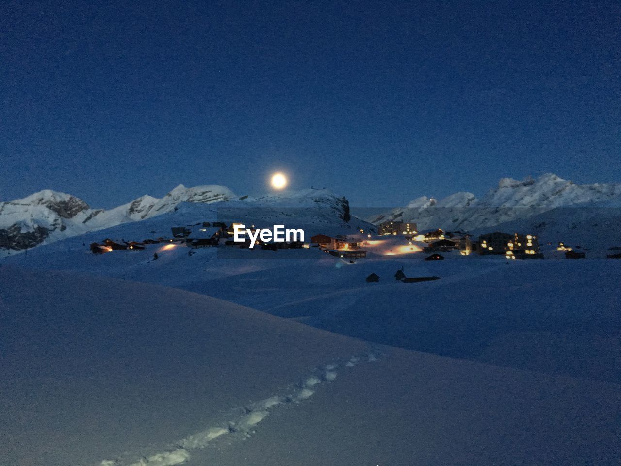 VIEW OF ILLUMINATED MOUNTAINS AT NIGHT