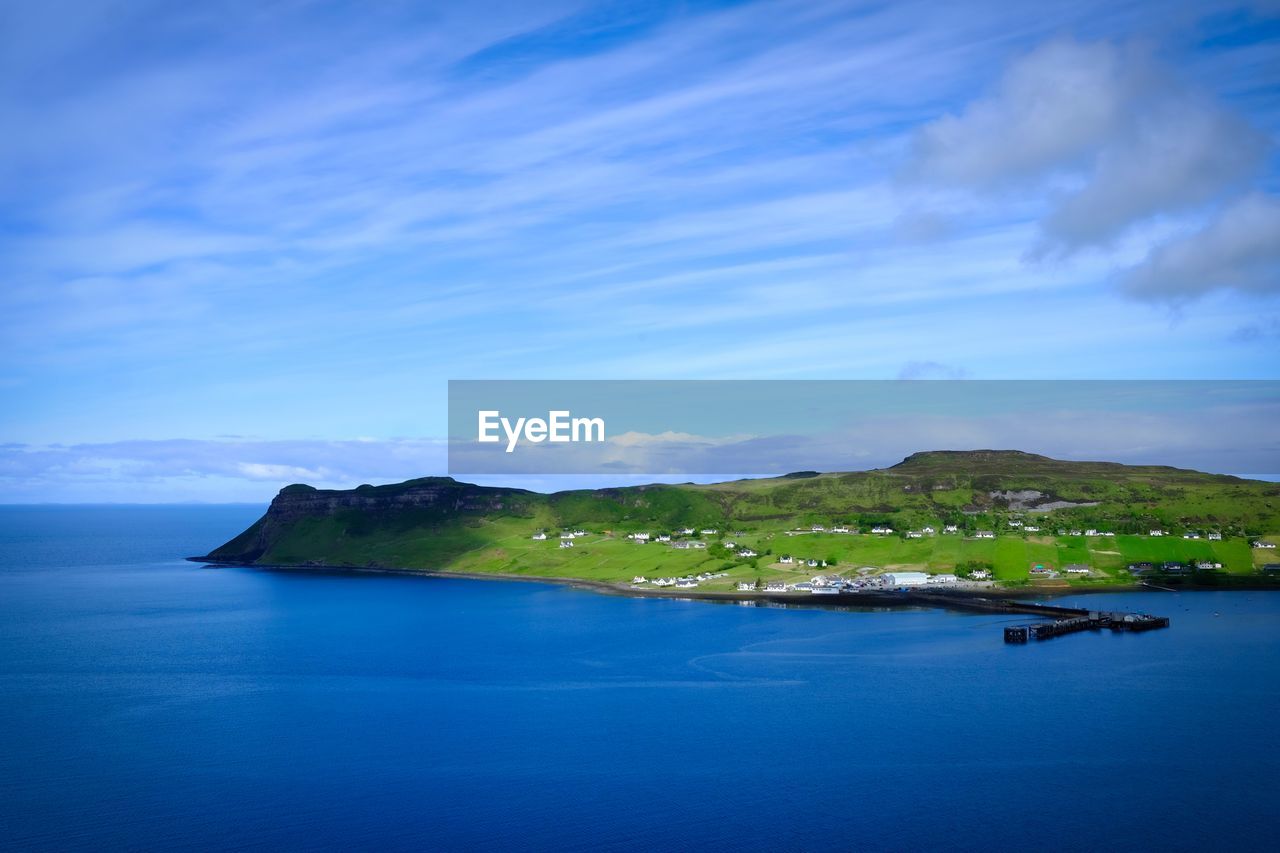 SCENIC VIEW OF BAY AGAINST BLUE SKY