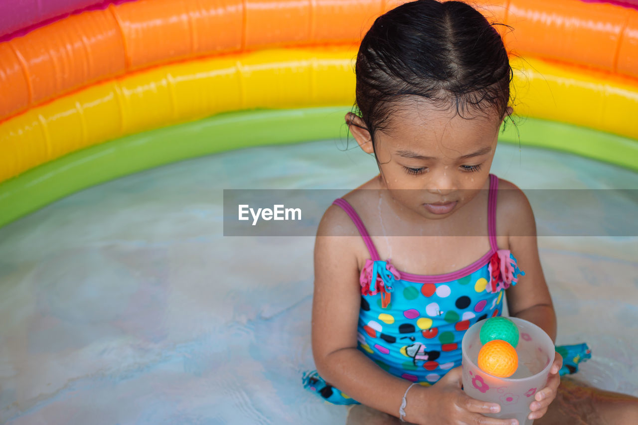 Girl playing in wading pool