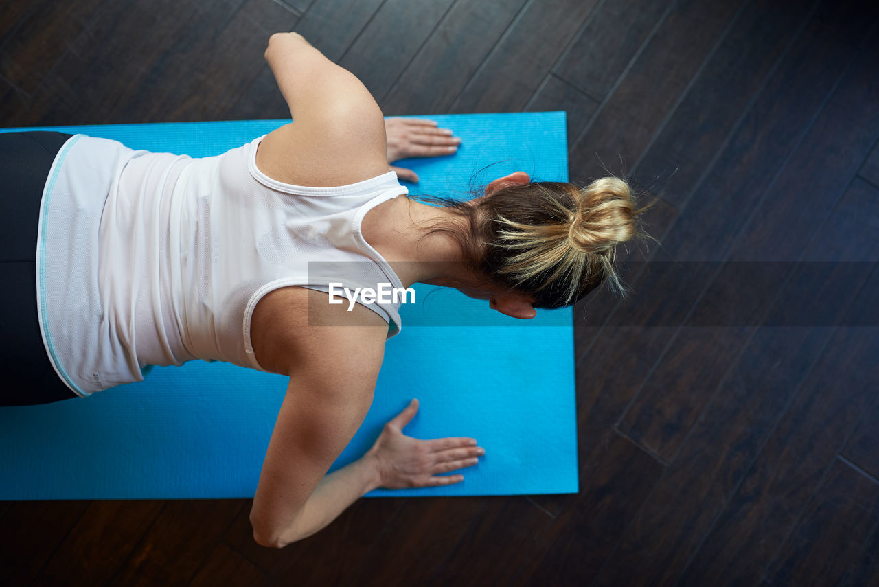 Overhead view of woman exercising at home