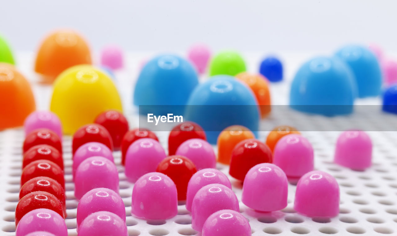 multi colored, large group of objects, no people, food, close-up, variation, indoors, selective focus, abundance, in a row, sweet, studio shot, sweet food, still life, dessert, candy, pink