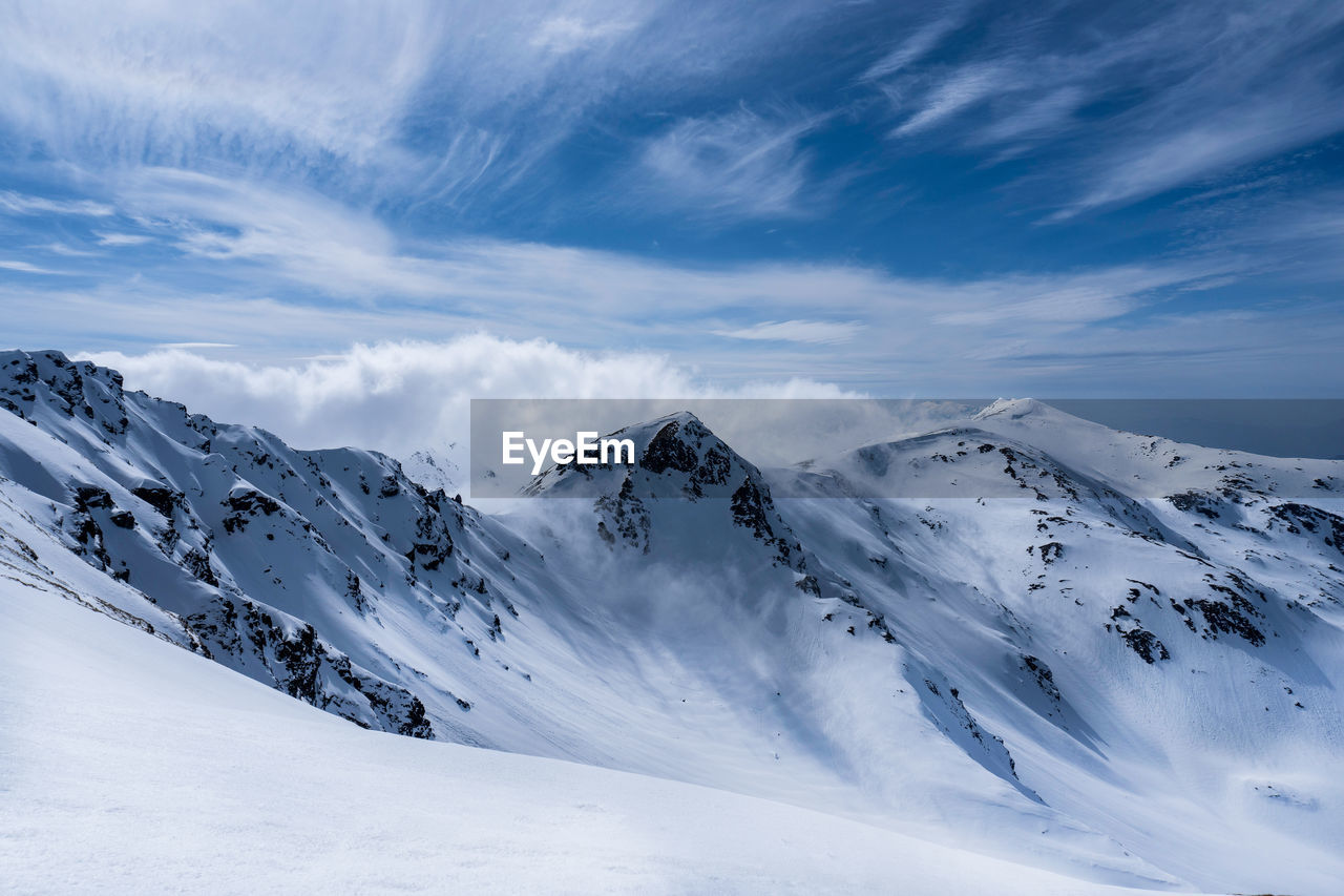 Scenic view of snowcapped mountains against sky