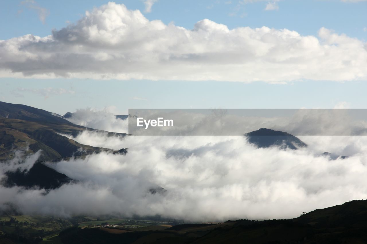 Scenic view of clouds amidst mountains against sky