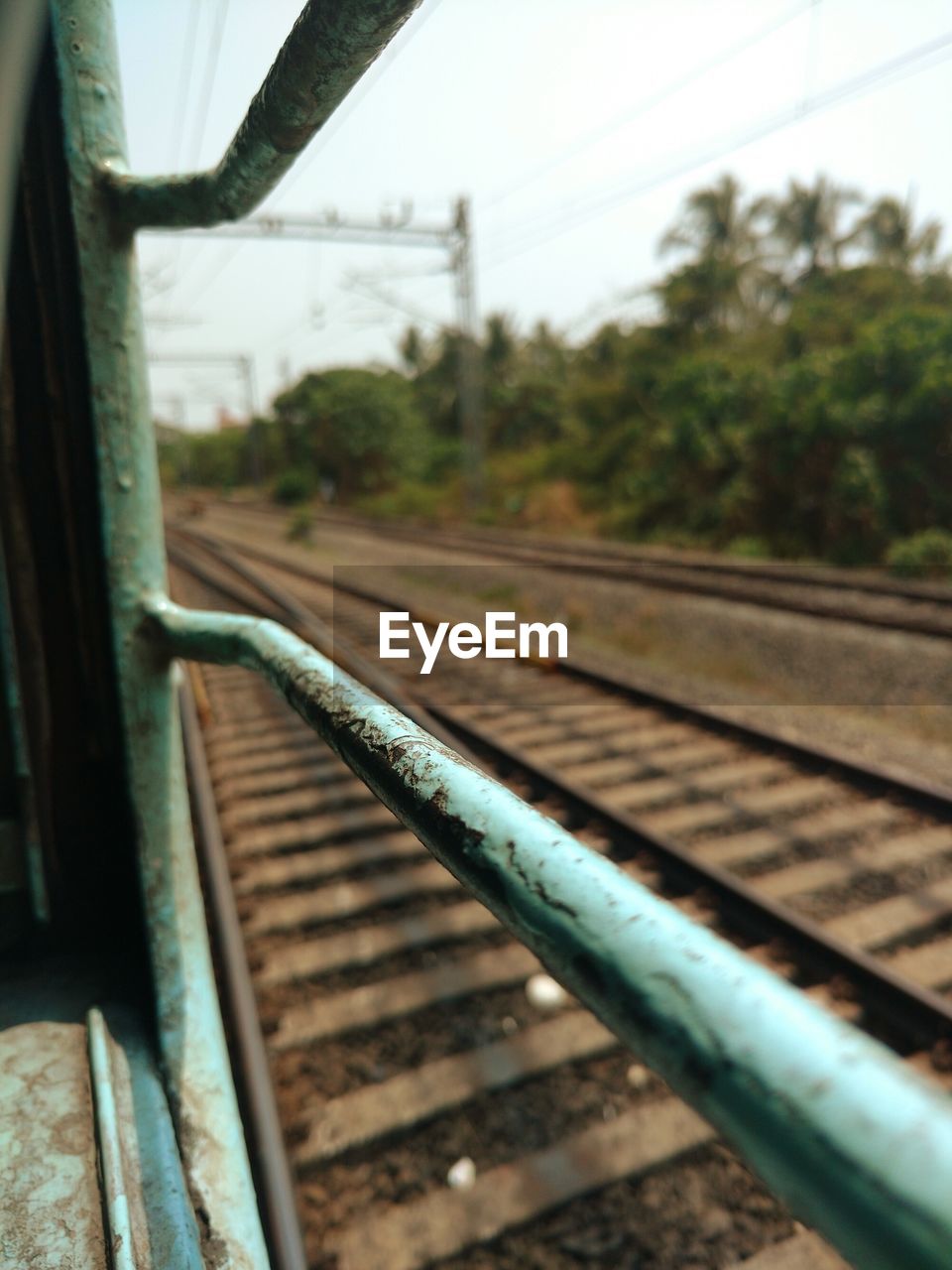 Railroad tracks seen through train window