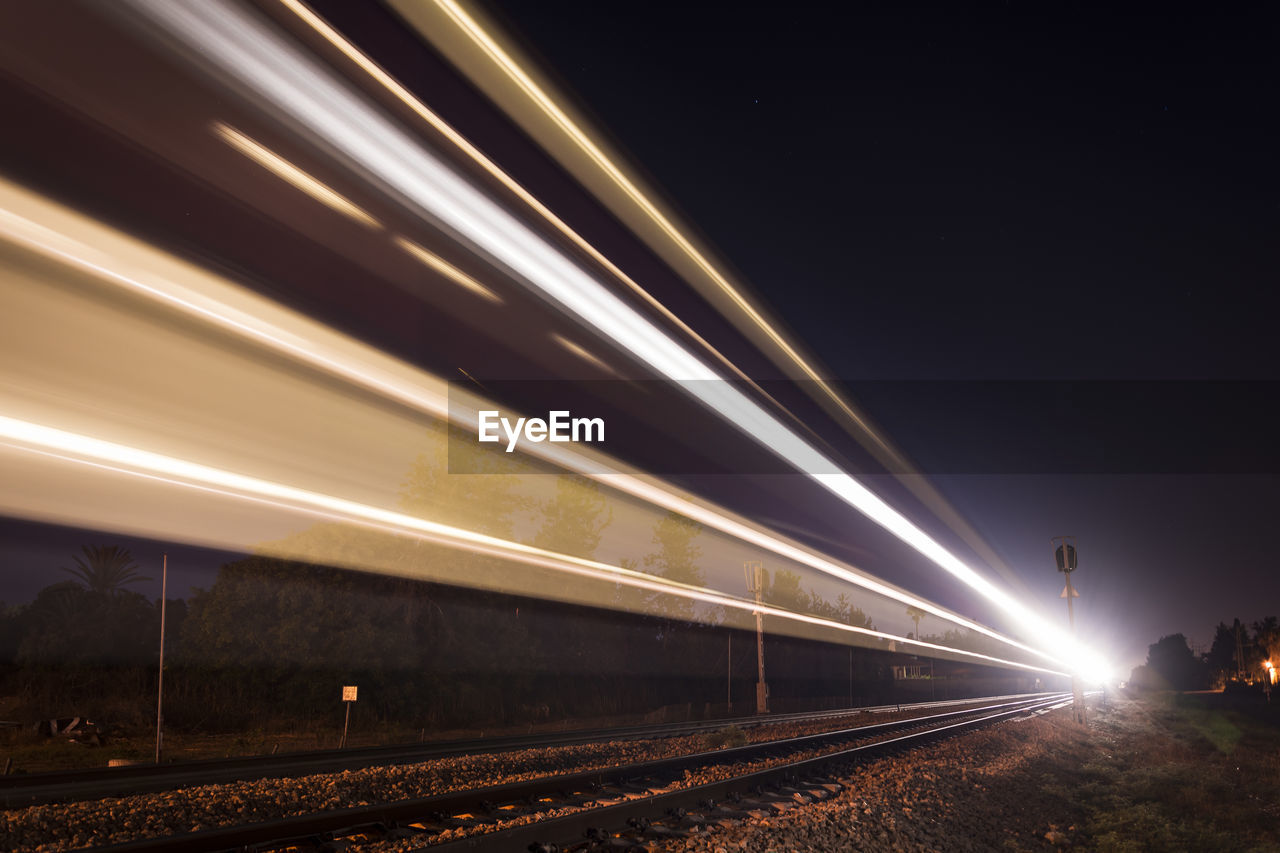 Light trails on railroad track at night