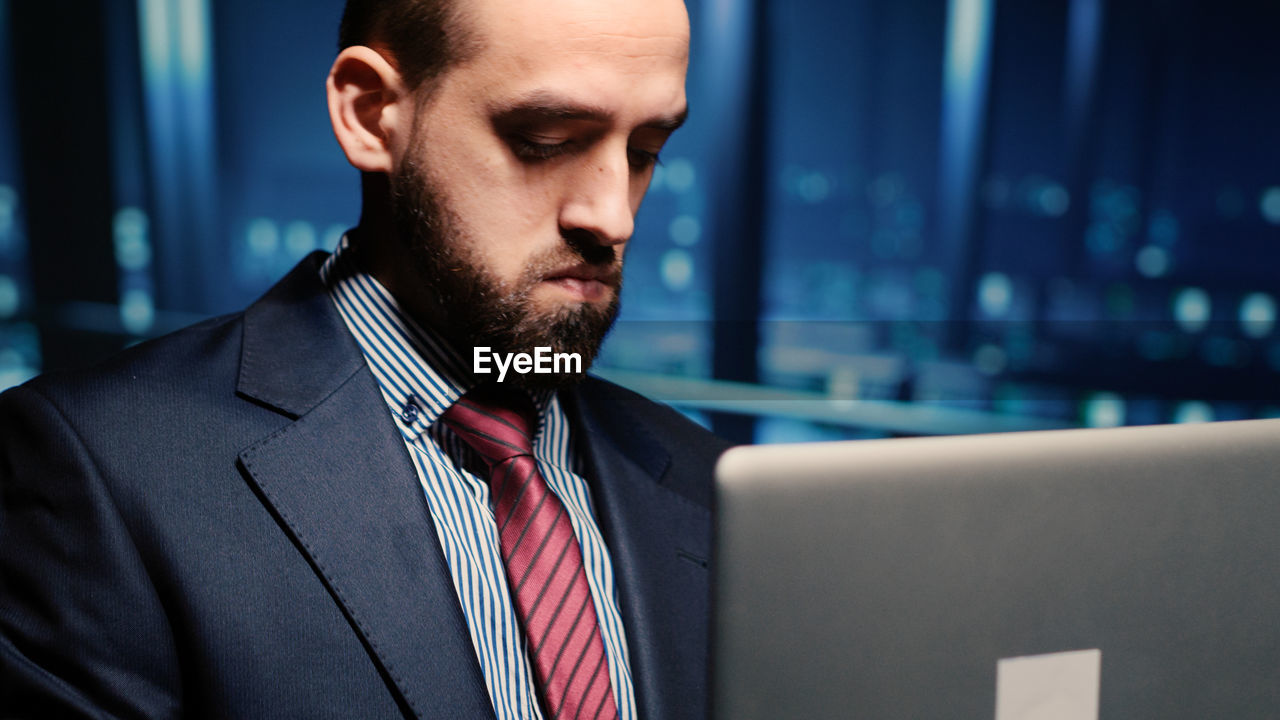 portrait of businessman looking at laptop