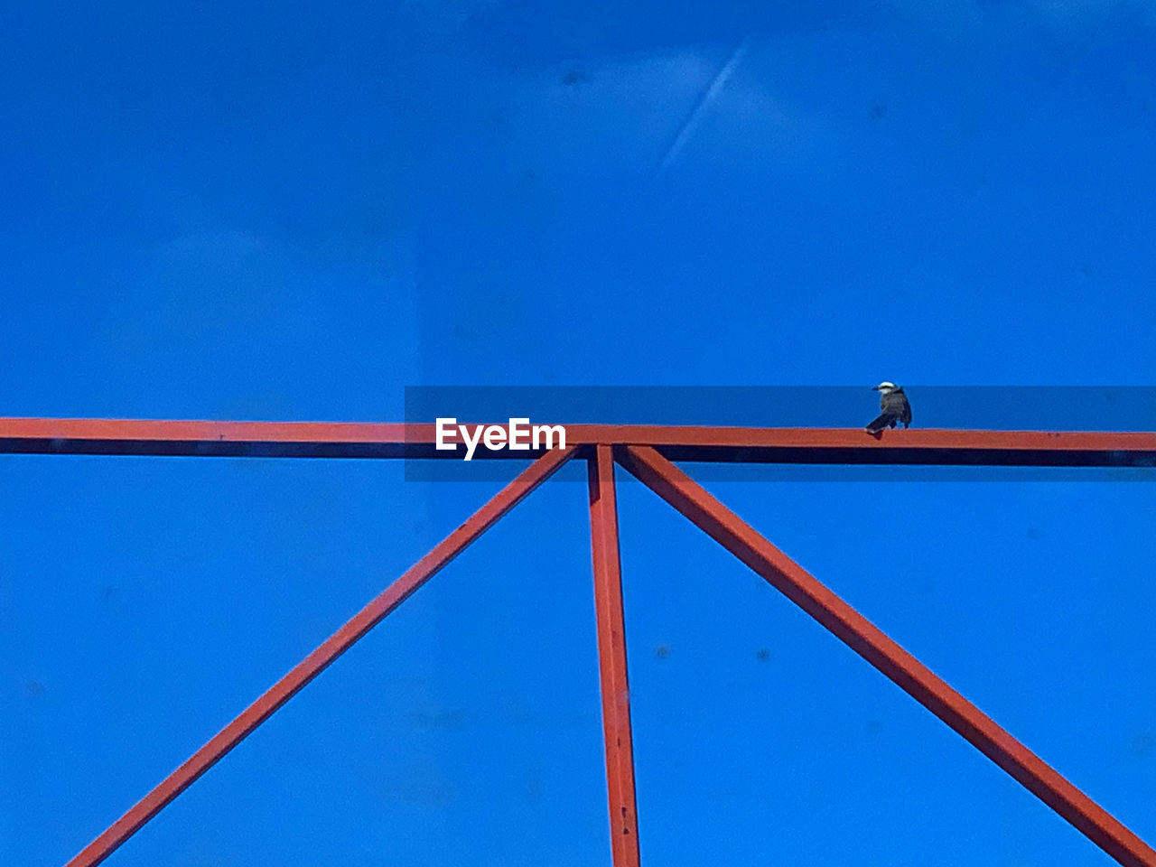 LOW ANGLE VIEW OF METALLIC STRUCTURE AGAINST BLUE SKY