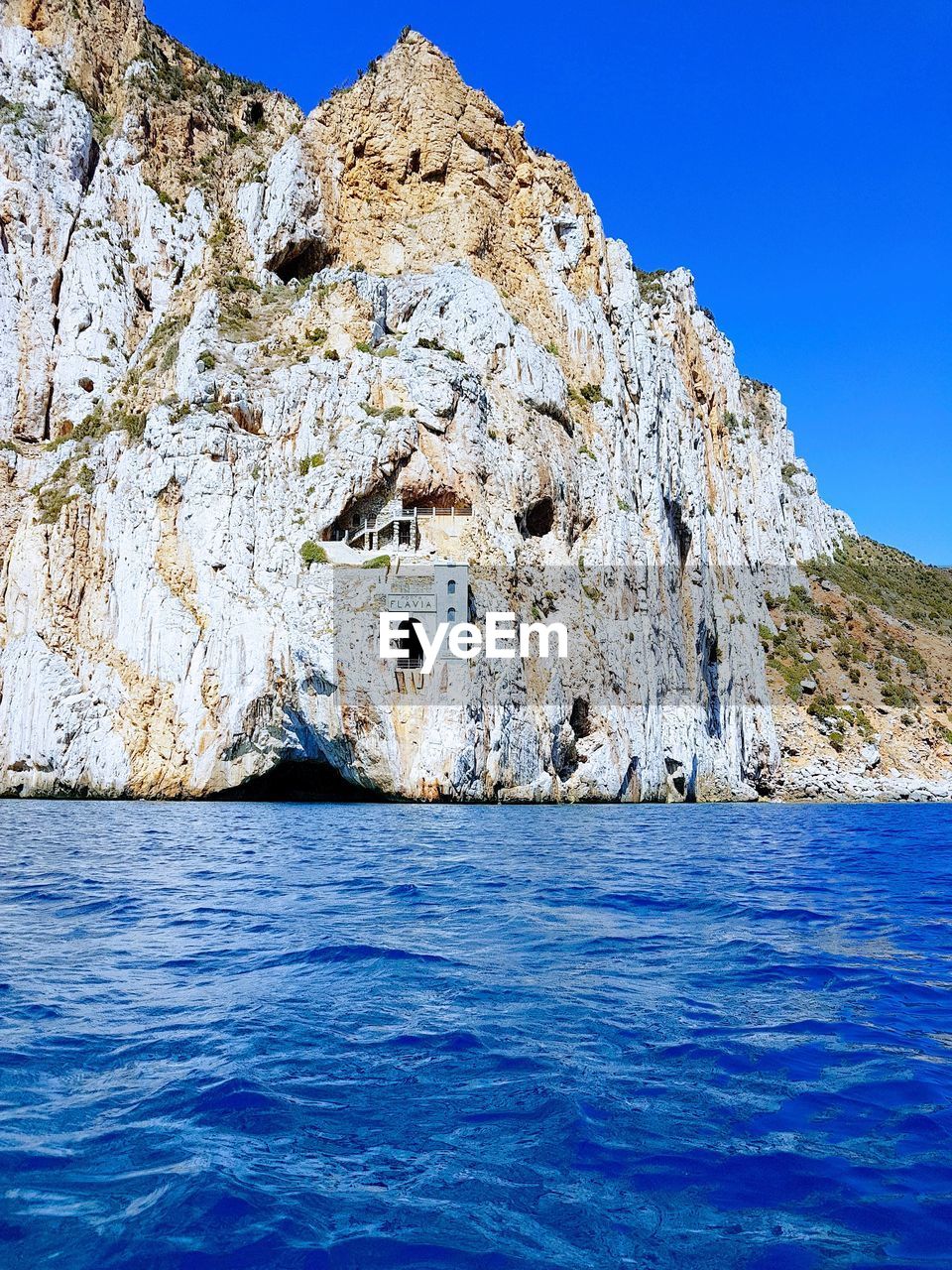 Scenic view of sea against clear blue sky