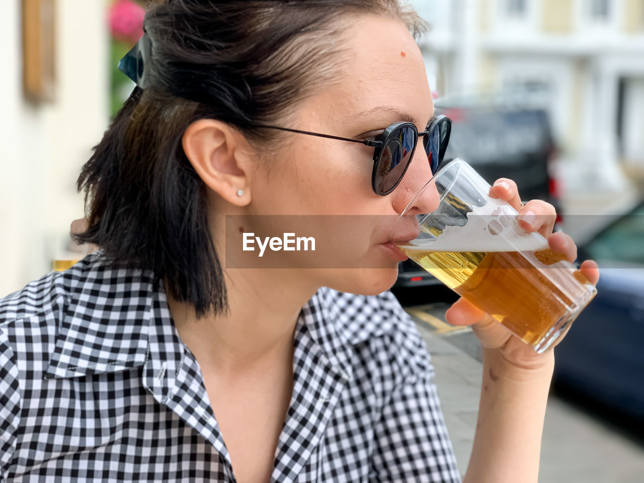 Young woman is drinking beer in a cafe or restaurant pub outdoor. drinking alcohol lager or ale beer