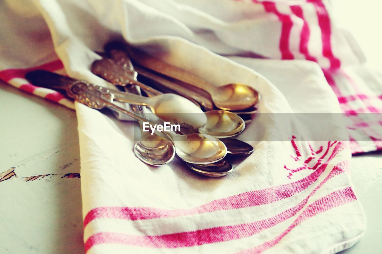 High angle view of spoons on napkin