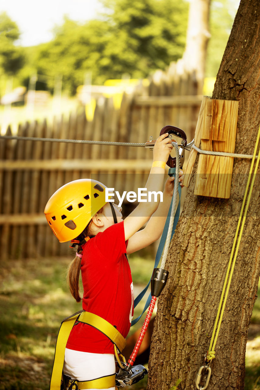 Girl zip lining in forest