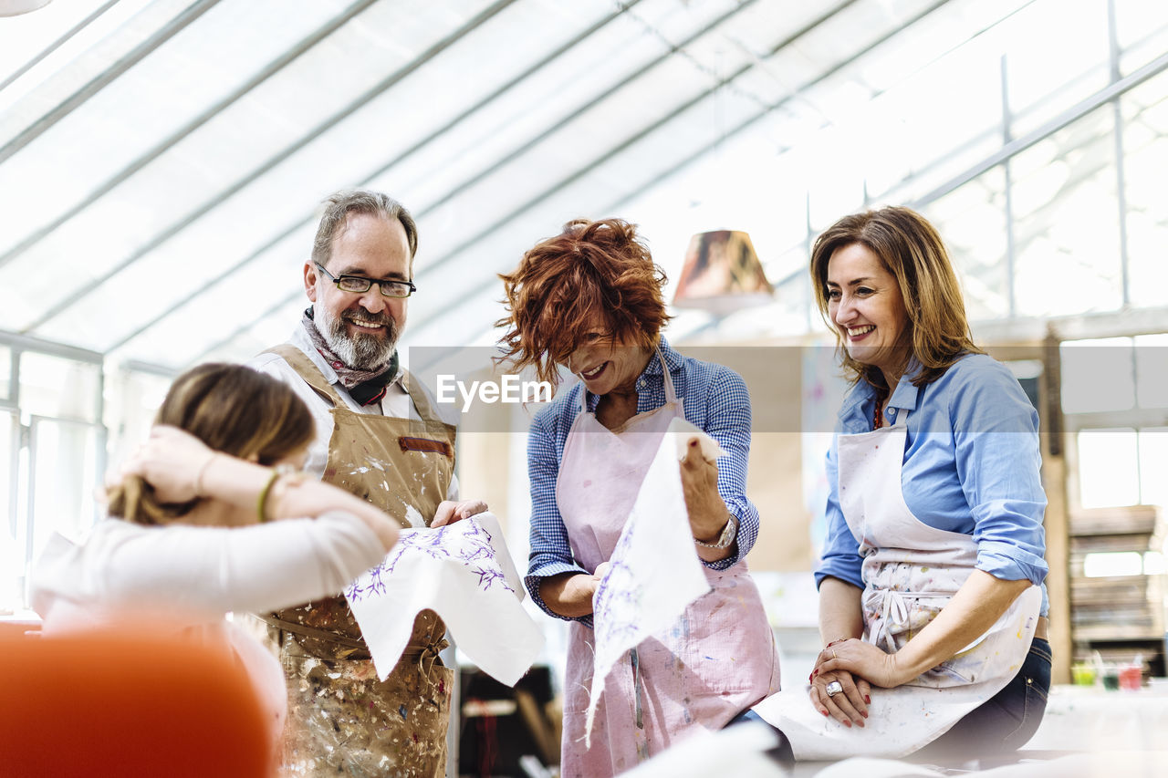 Laughing mature business owners with textile samples