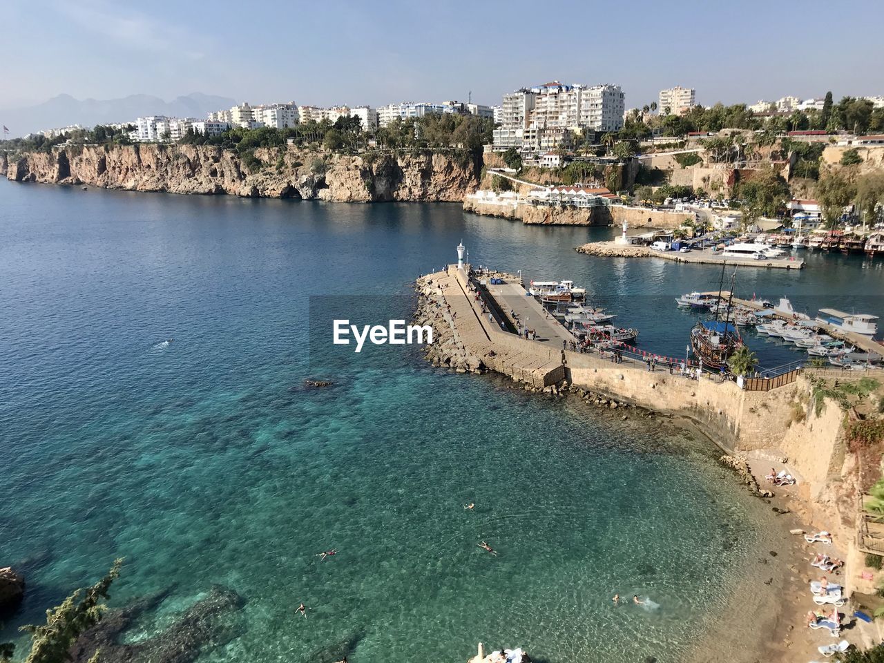 High angle view of sea by city against sky