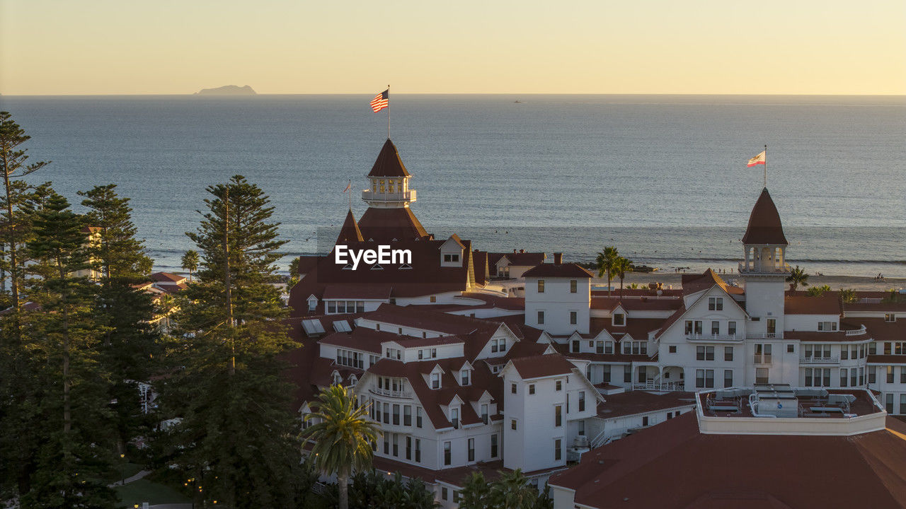 architecture, building exterior, built structure, sky, building, water, sunset, nature, travel destinations, sea, city, religion, place of worship, travel, horizon, belief, high angle view, tourism, horizon over water, history, the past, no people, tower, evening, scenics - nature, spirituality, tree, cityscape, beauty in nature, outdoors, land, urban skyline, roof, dusk, plant, vacation, sunlight, clear sky, coast, landscape, dome, holiday, transportation, residential district