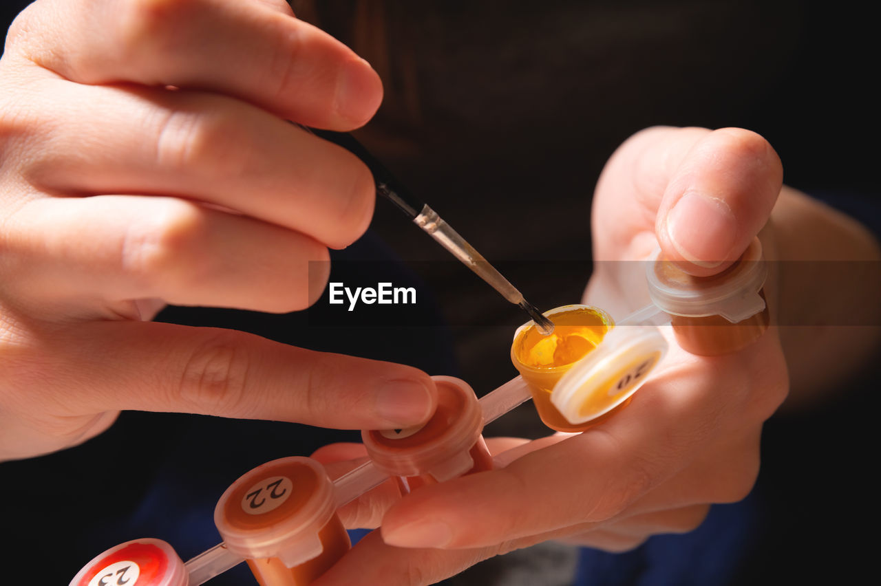 cropped hand of doctor holding syringe