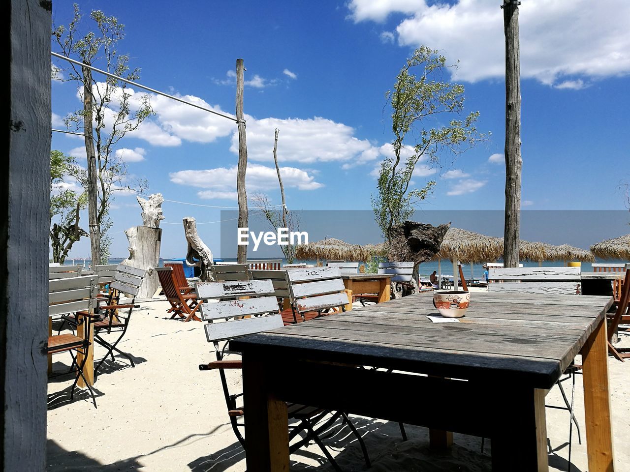 CHAIRS AND TABLES AGAINST SKY