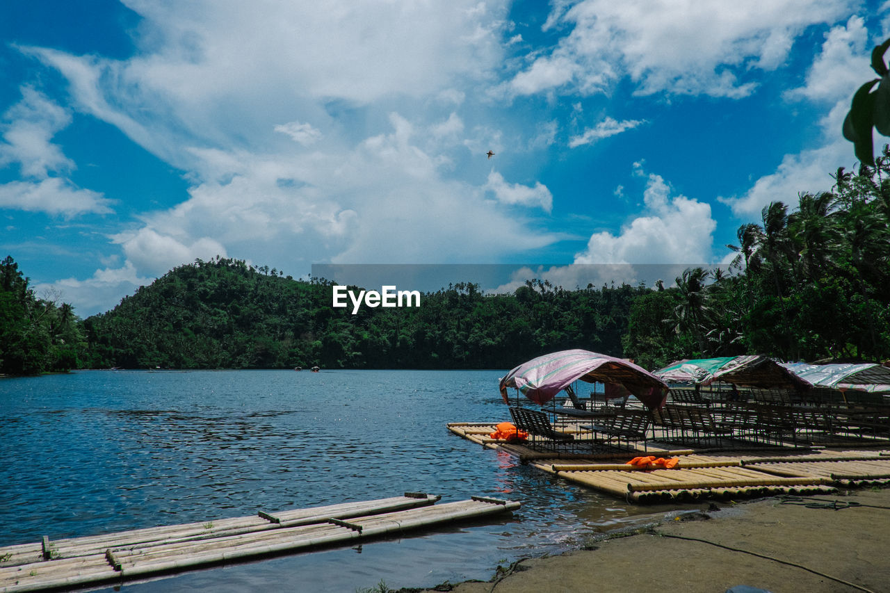 Boat moored on shore against sky