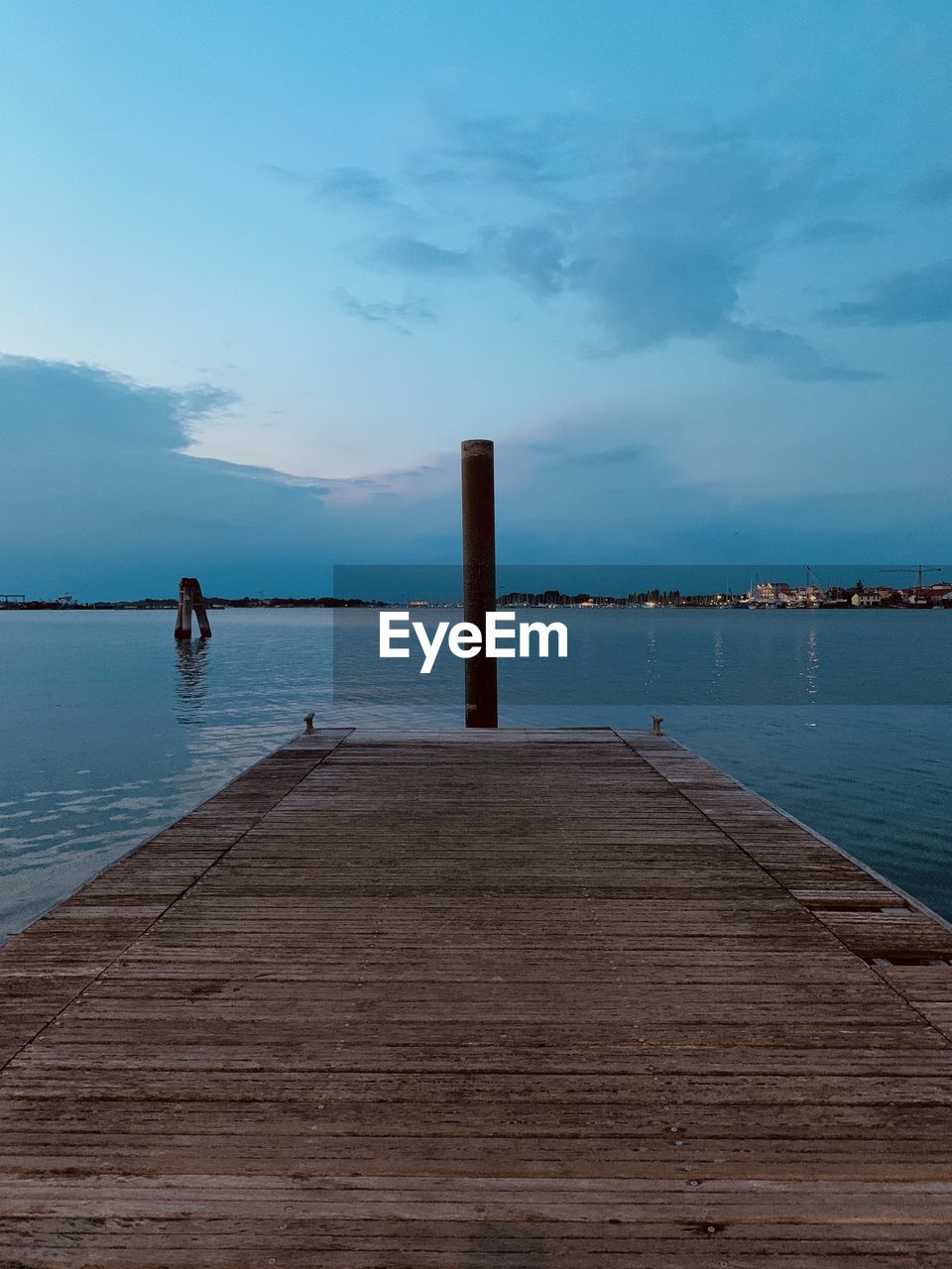 Wooden pier over sea against sky