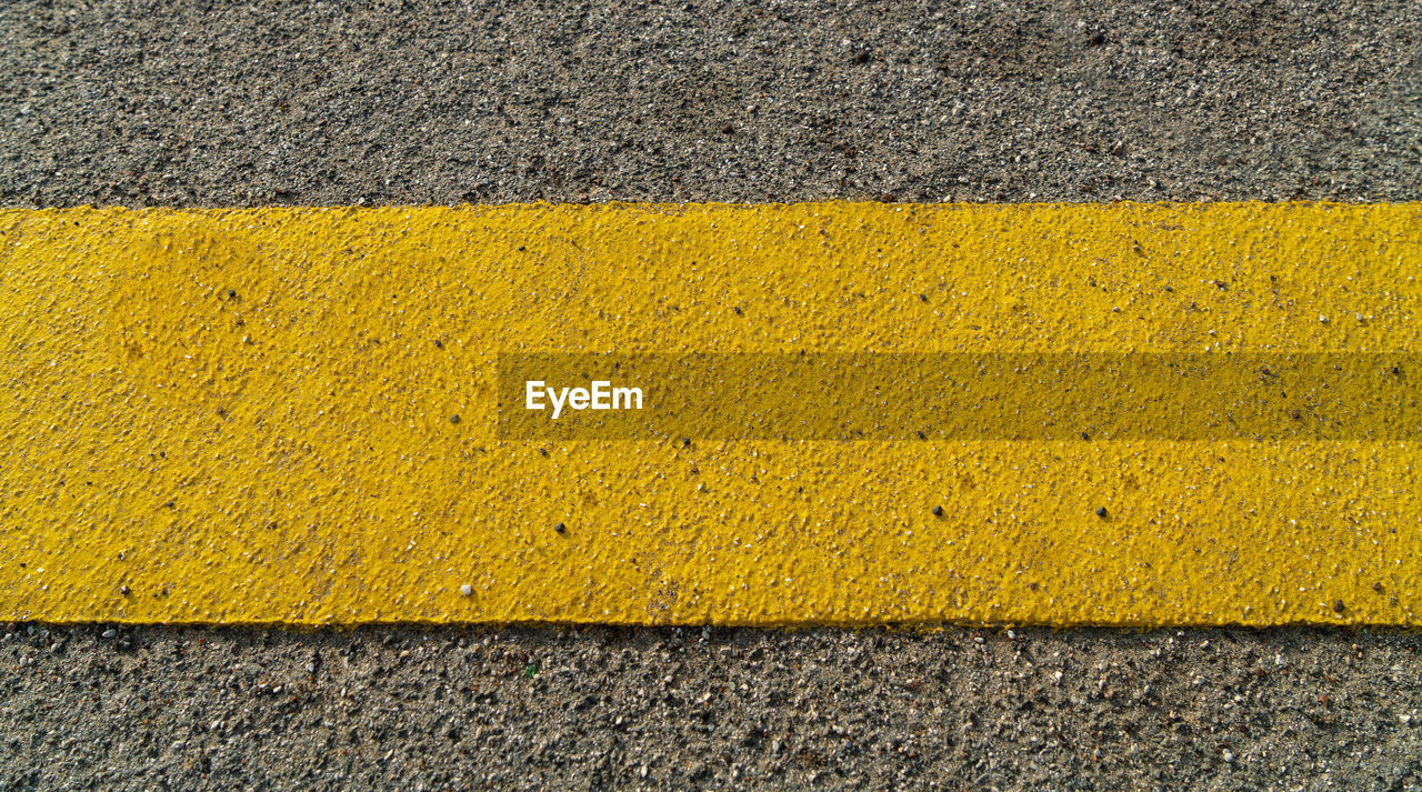 High angle view of yellow road marking on street