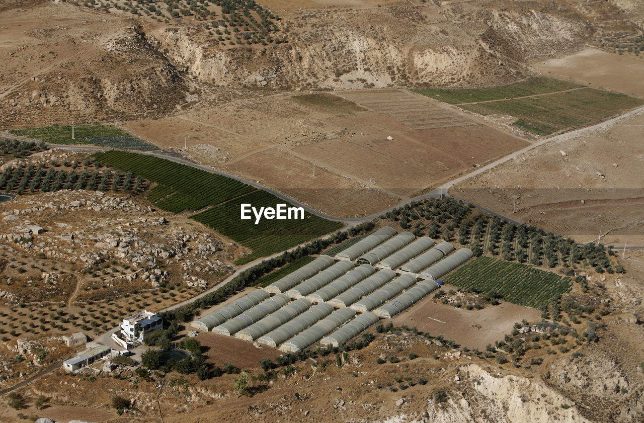 Aerial view of greenhouses and field