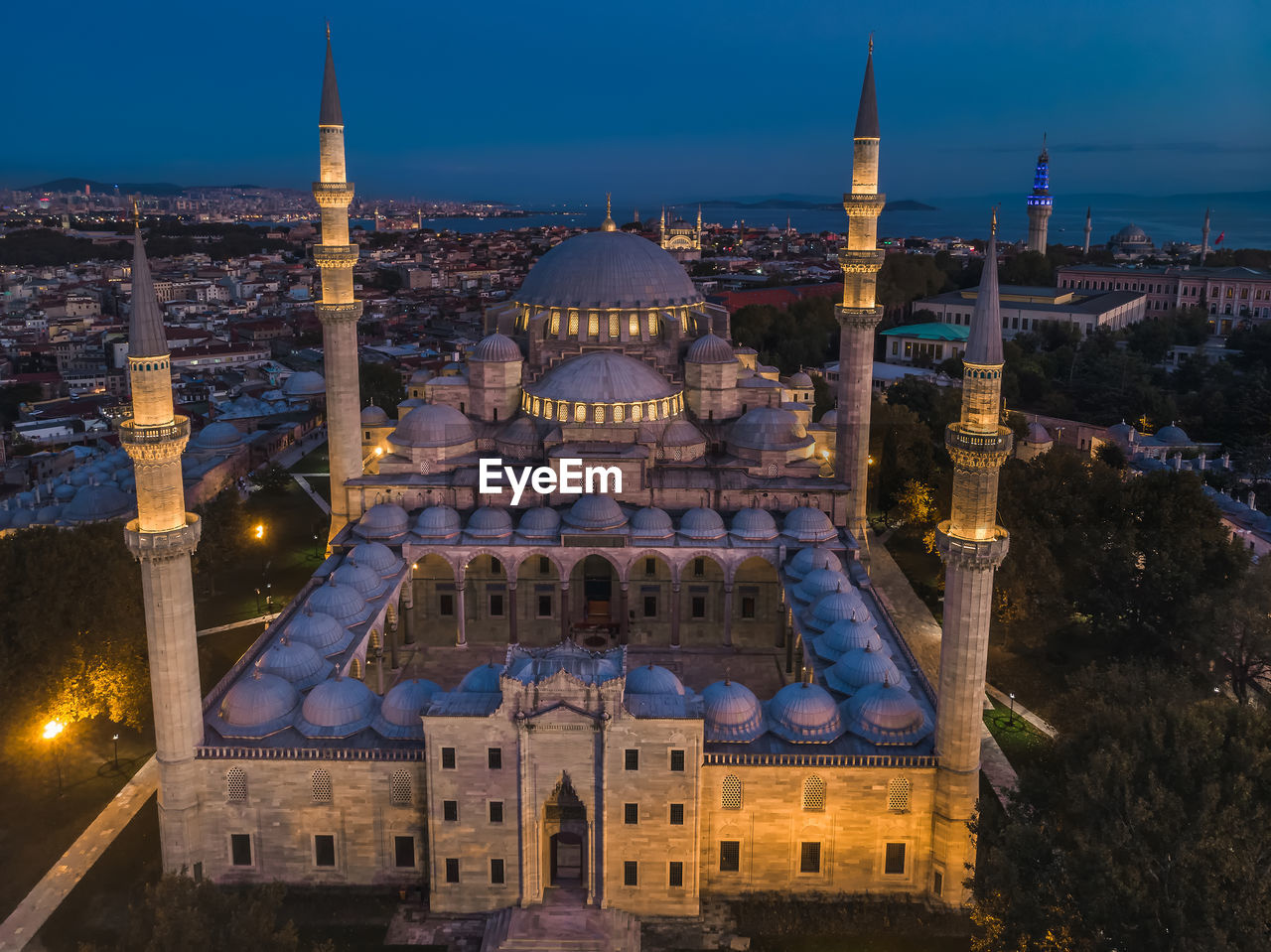 HIGH ANGLE VIEW OF ILLUMINATED BUILDINGS IN CITY