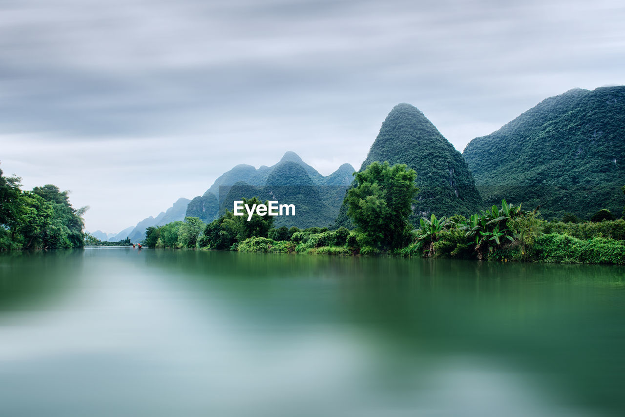 Scenic view of lake and mountains against sky