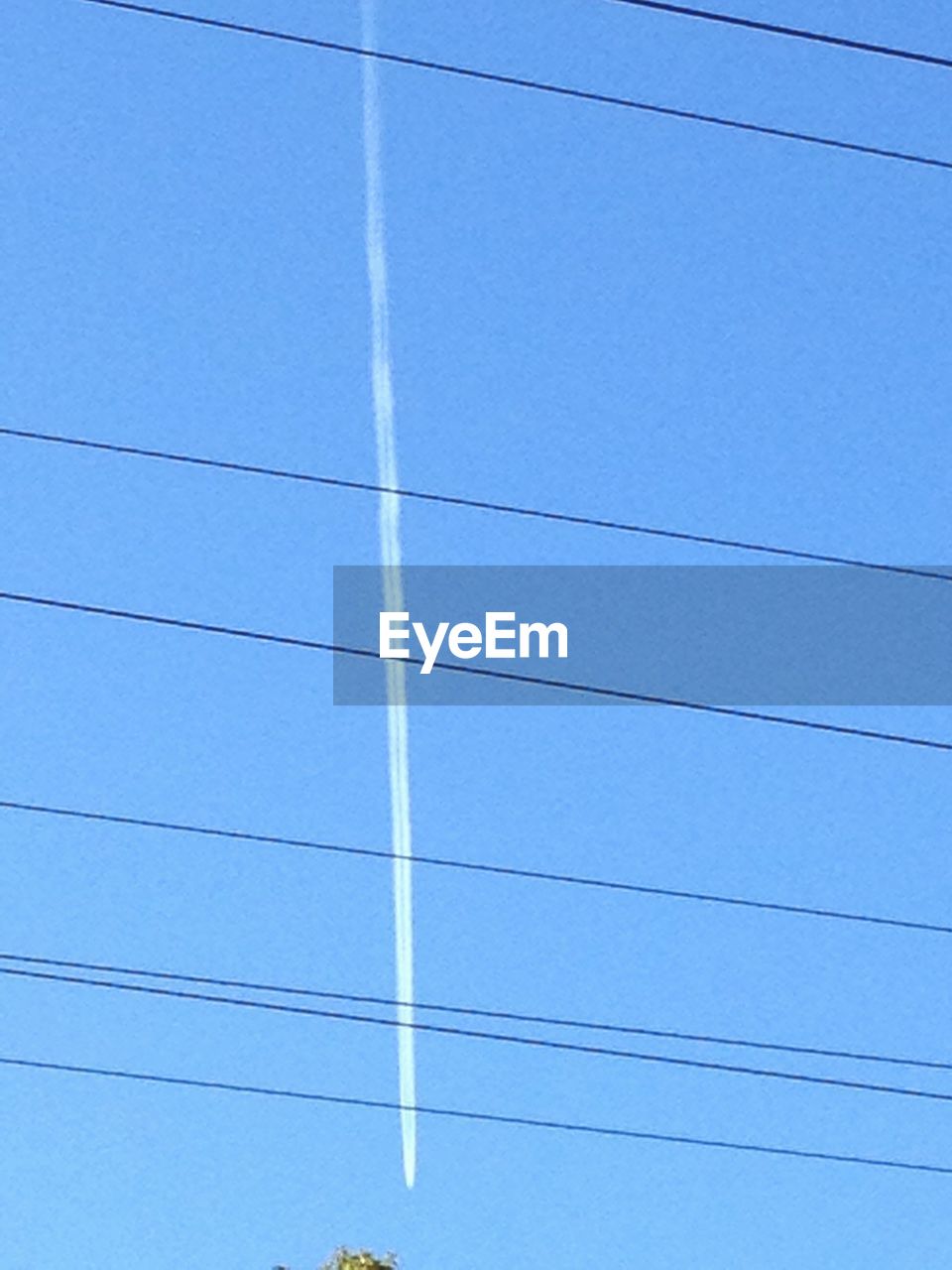 LOW ANGLE VIEW OF POWER LINES AGAINST BLUE SKY