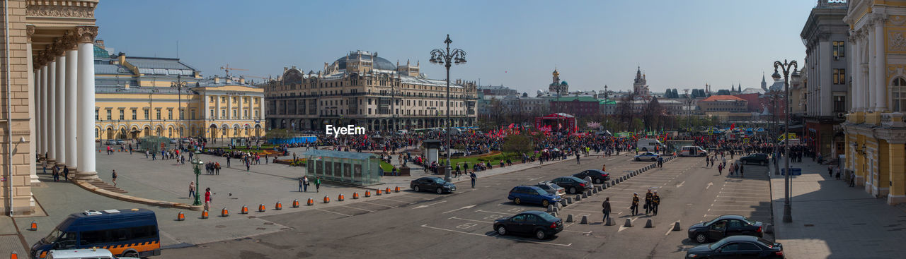 GROUP OF PEOPLE ON STREET AGAINST BUILDINGS