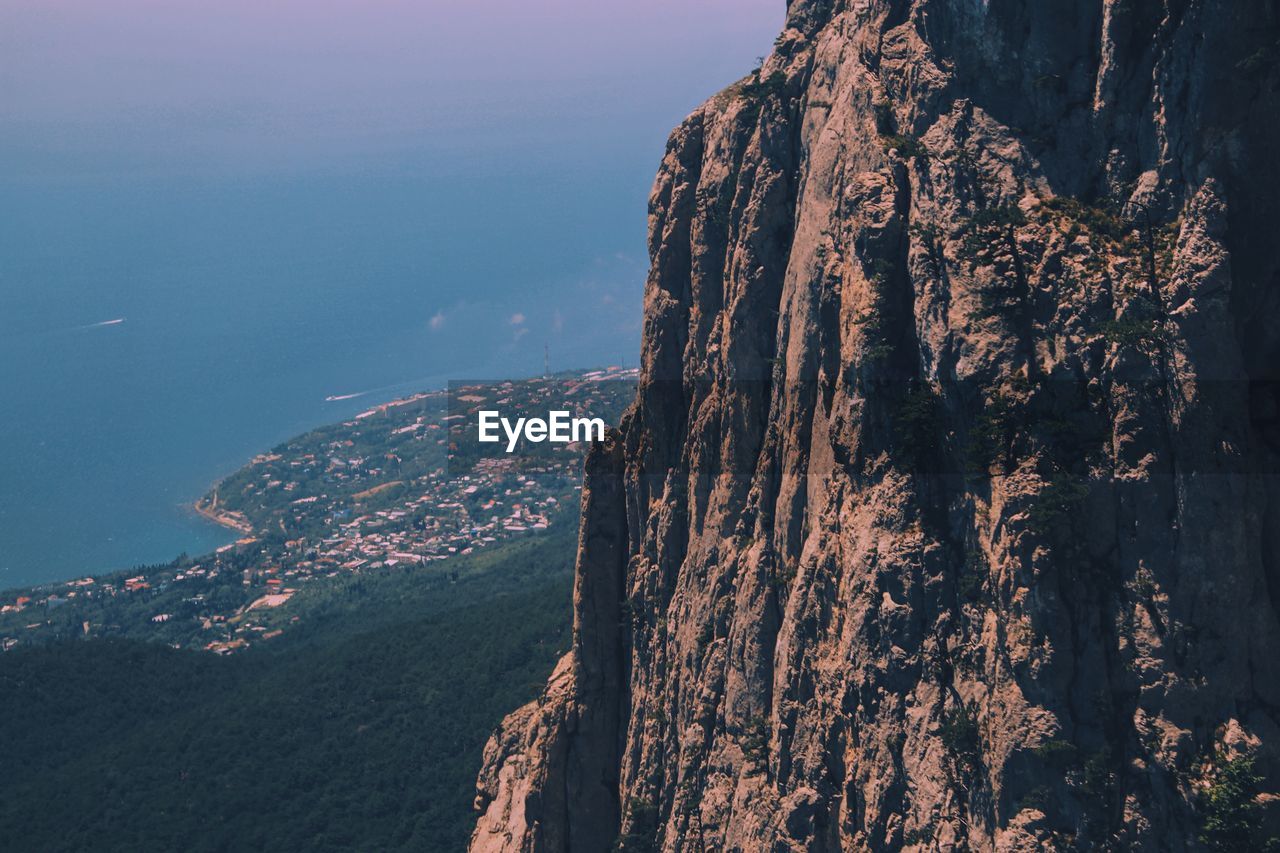 Scenic view of rocky mountain above beach landscape