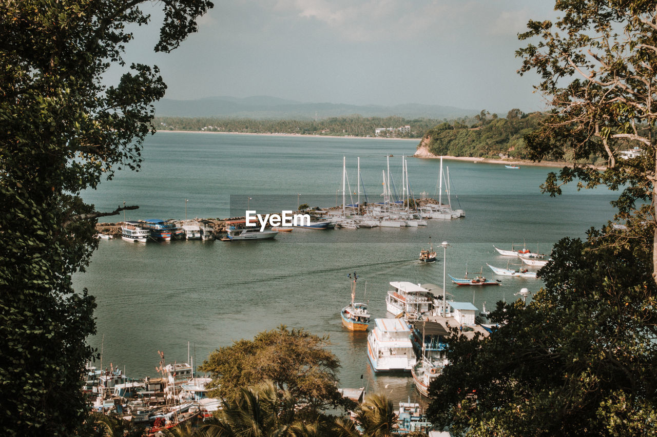 High angle view of harbor by sea against sky