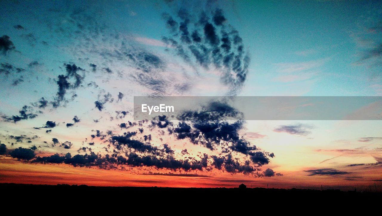 Silhouette of landscape against dramatic sky