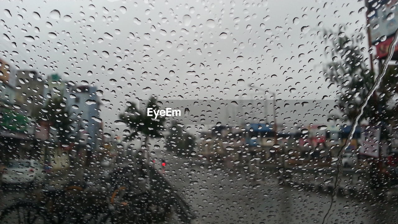 Full frame shot of raindrops on car windshield