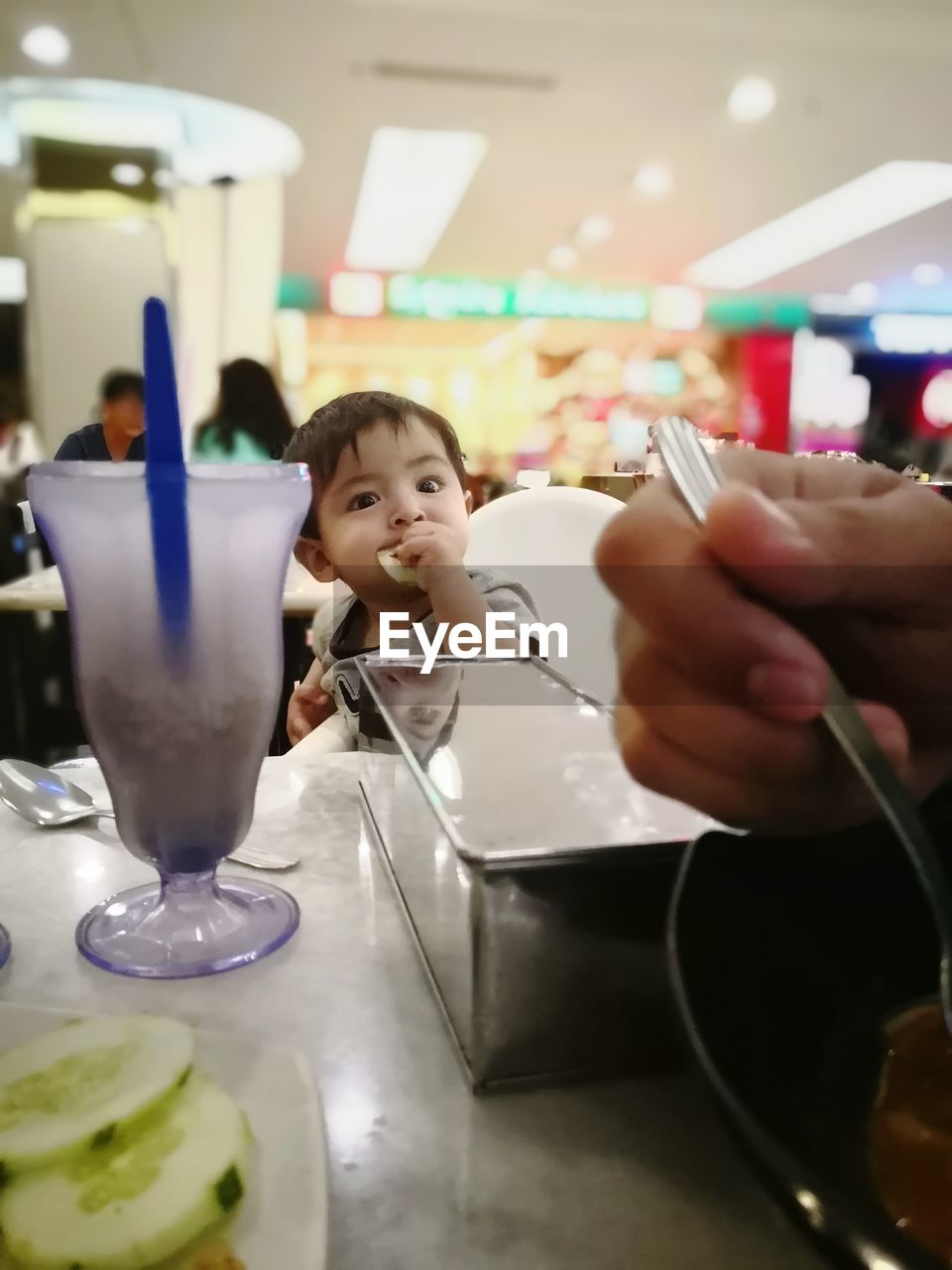 PORTRAIT OF BOY HOLDING COFFEE AT HOME