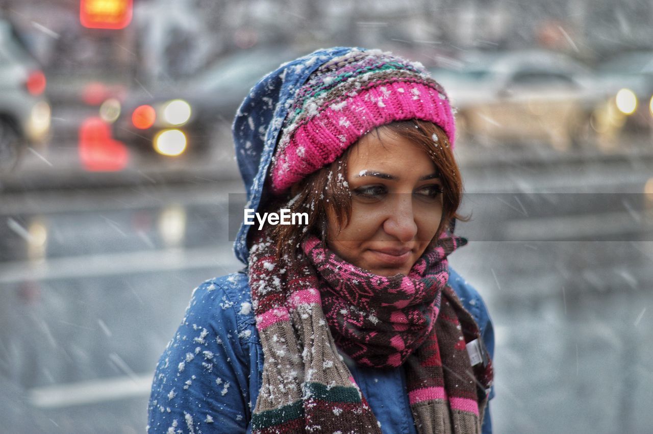 Smiling beautiful woman wearing warm clothing during winter