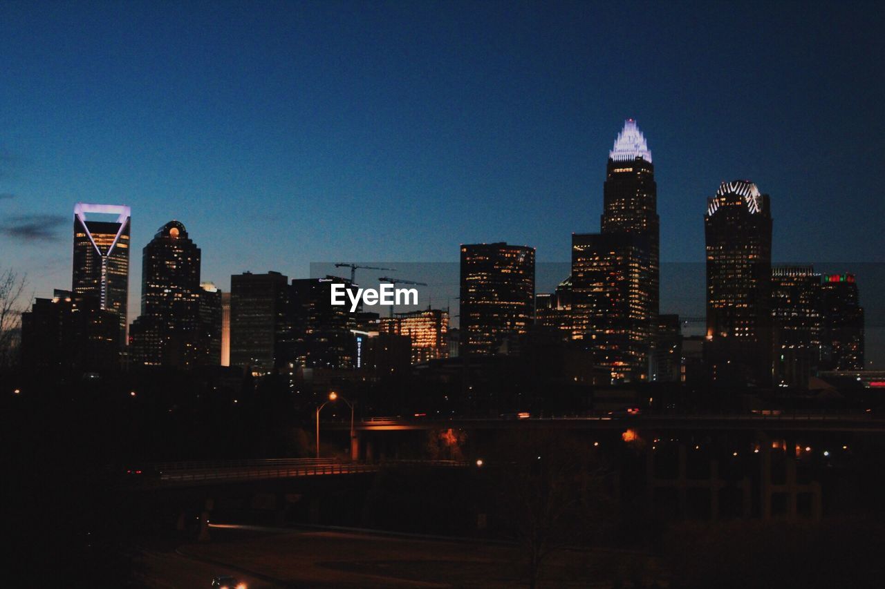 View of skyscrapers lit up at night