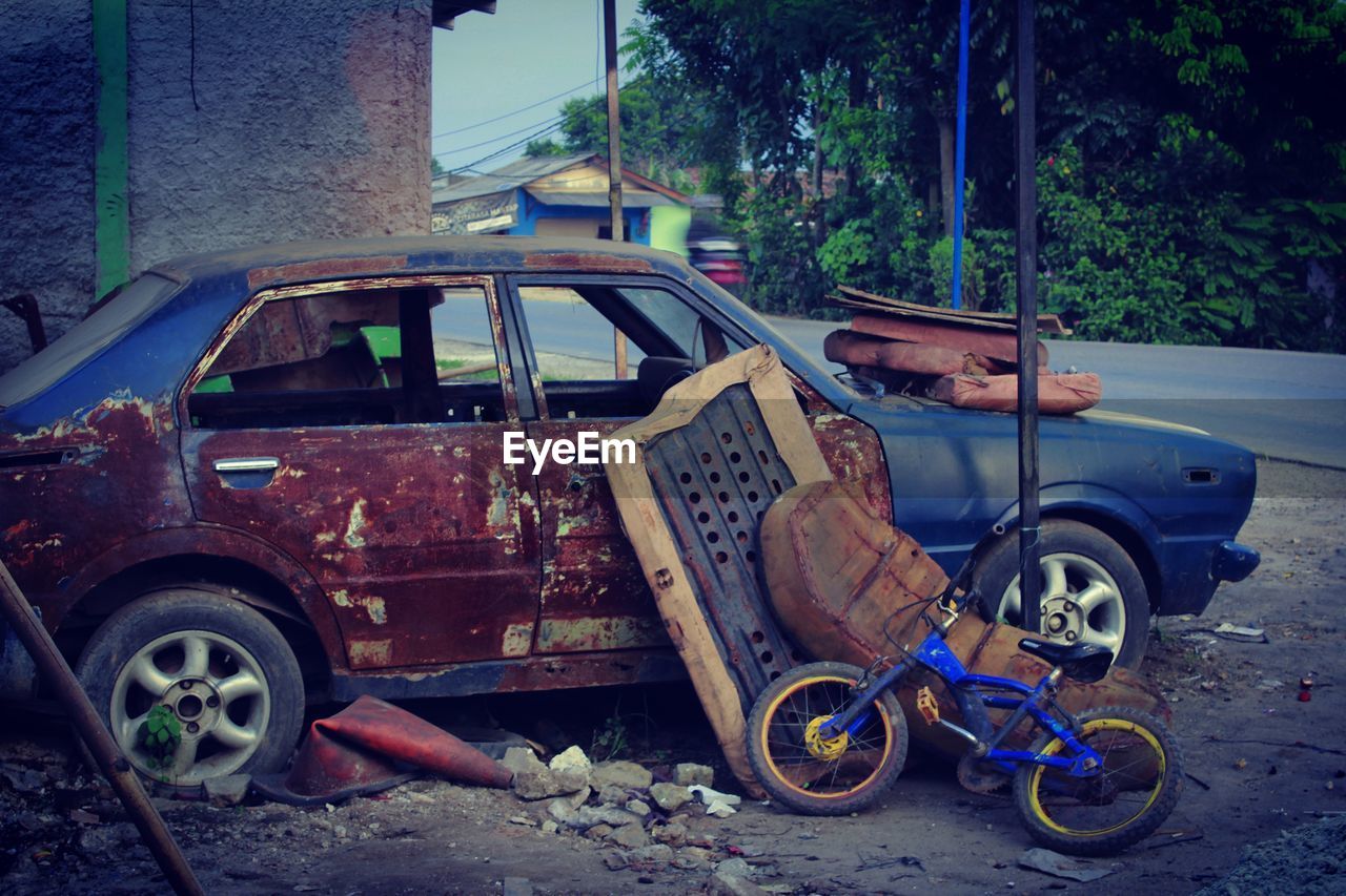 Abandoned car parked by road