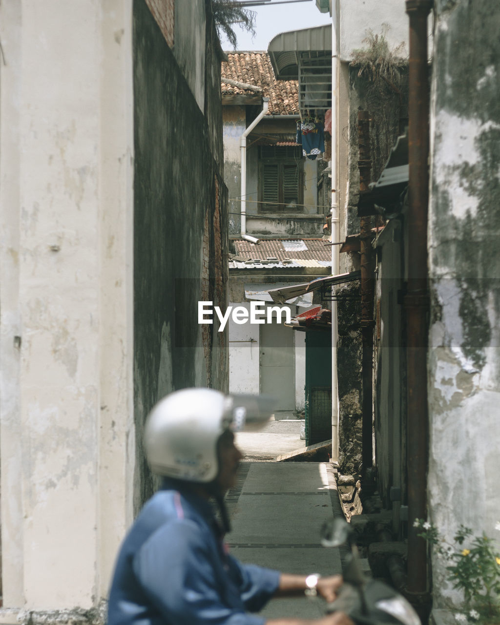 REAR VIEW OF PEOPLE ON BUILDING