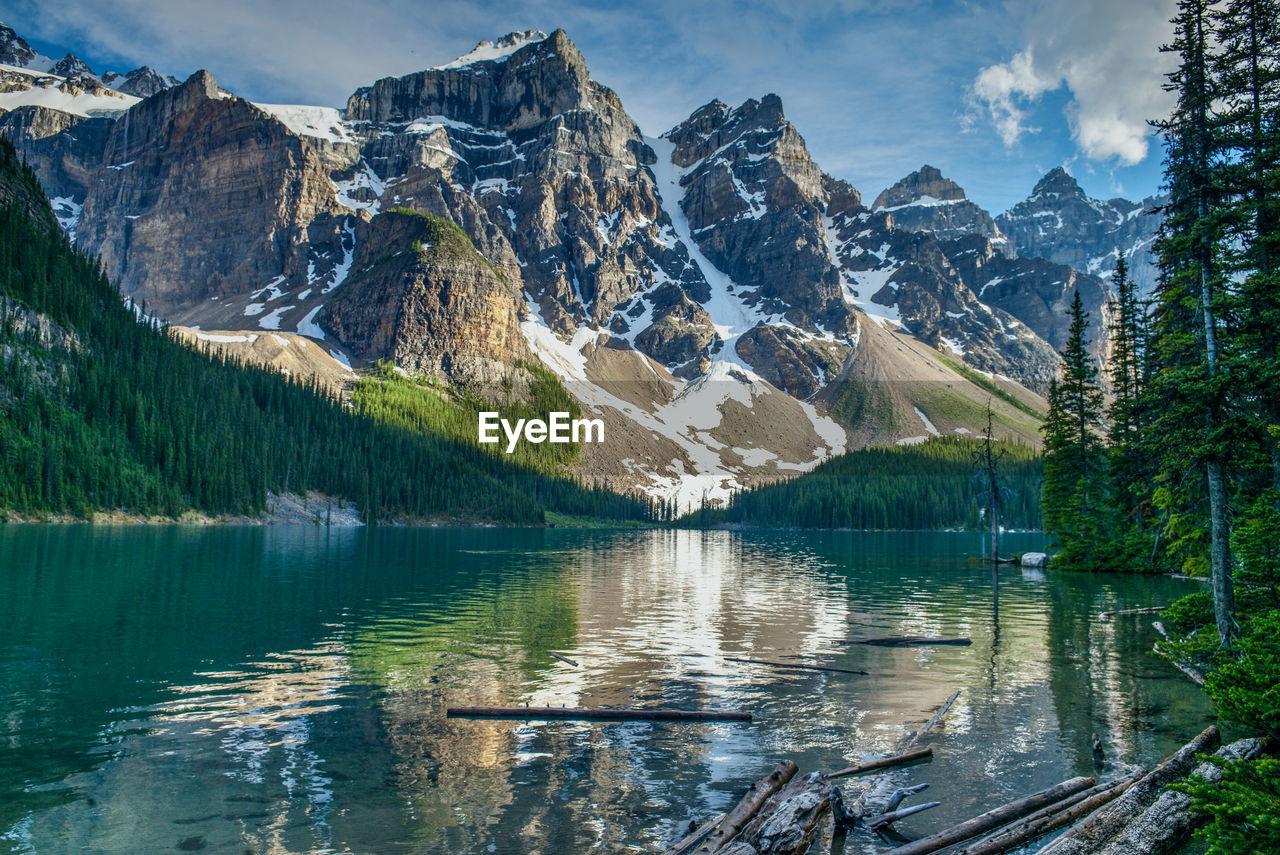 SCENIC VIEW OF LAKE BY MOUNTAIN AGAINST SKY