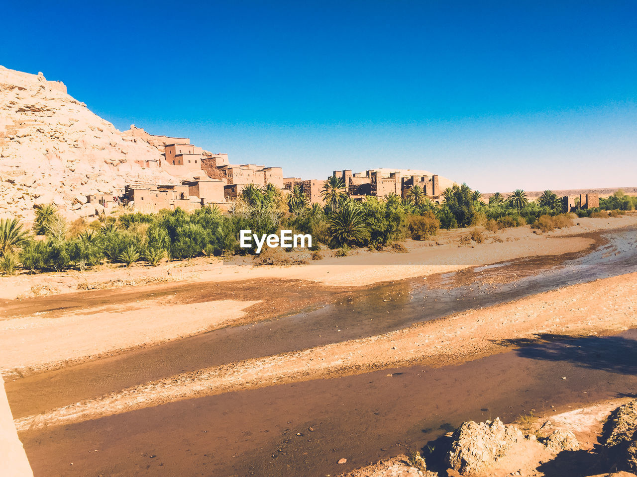 Scenic view of desert against clear blue sky