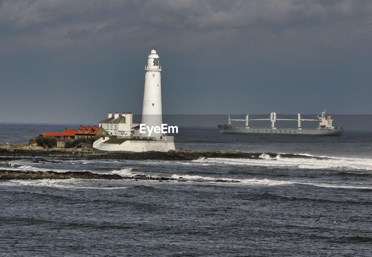 Whitley bay lighthouse as a ship passes by