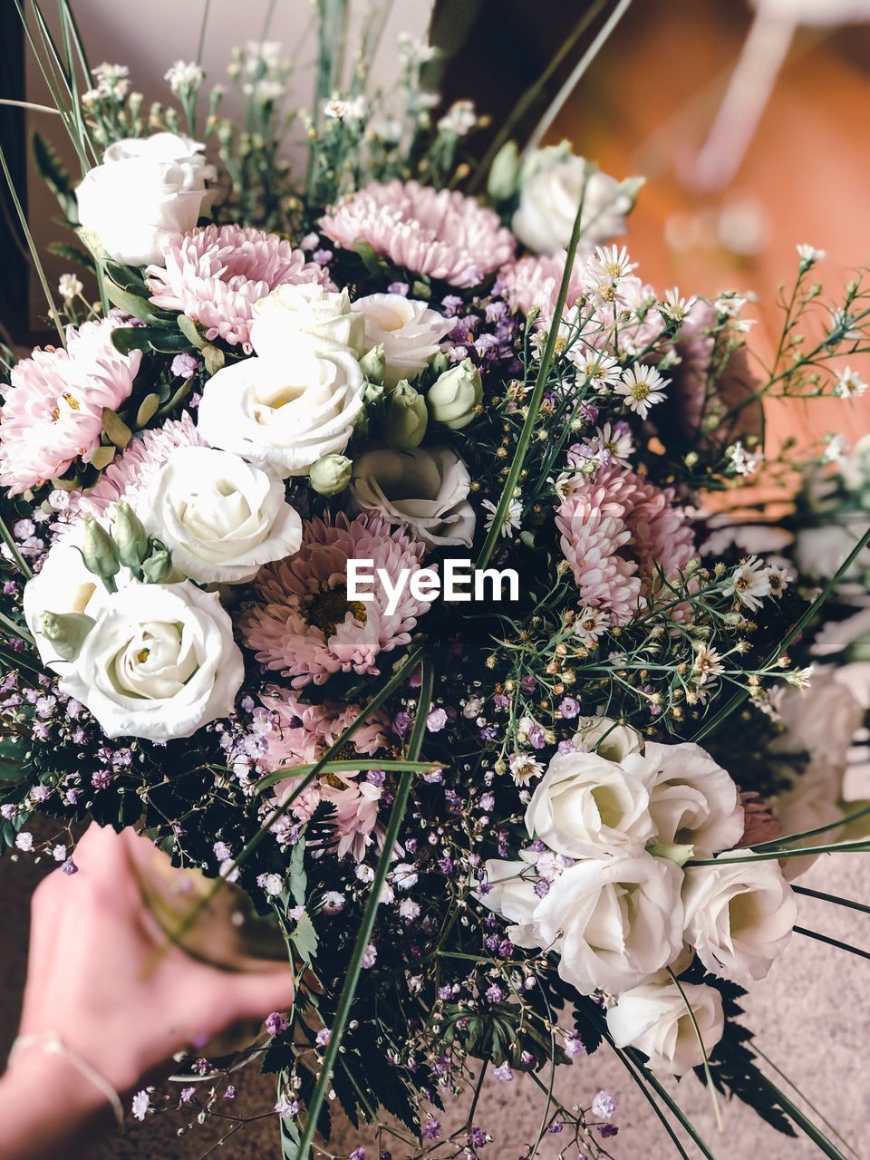 Cropped hand of person holding flower bouquet