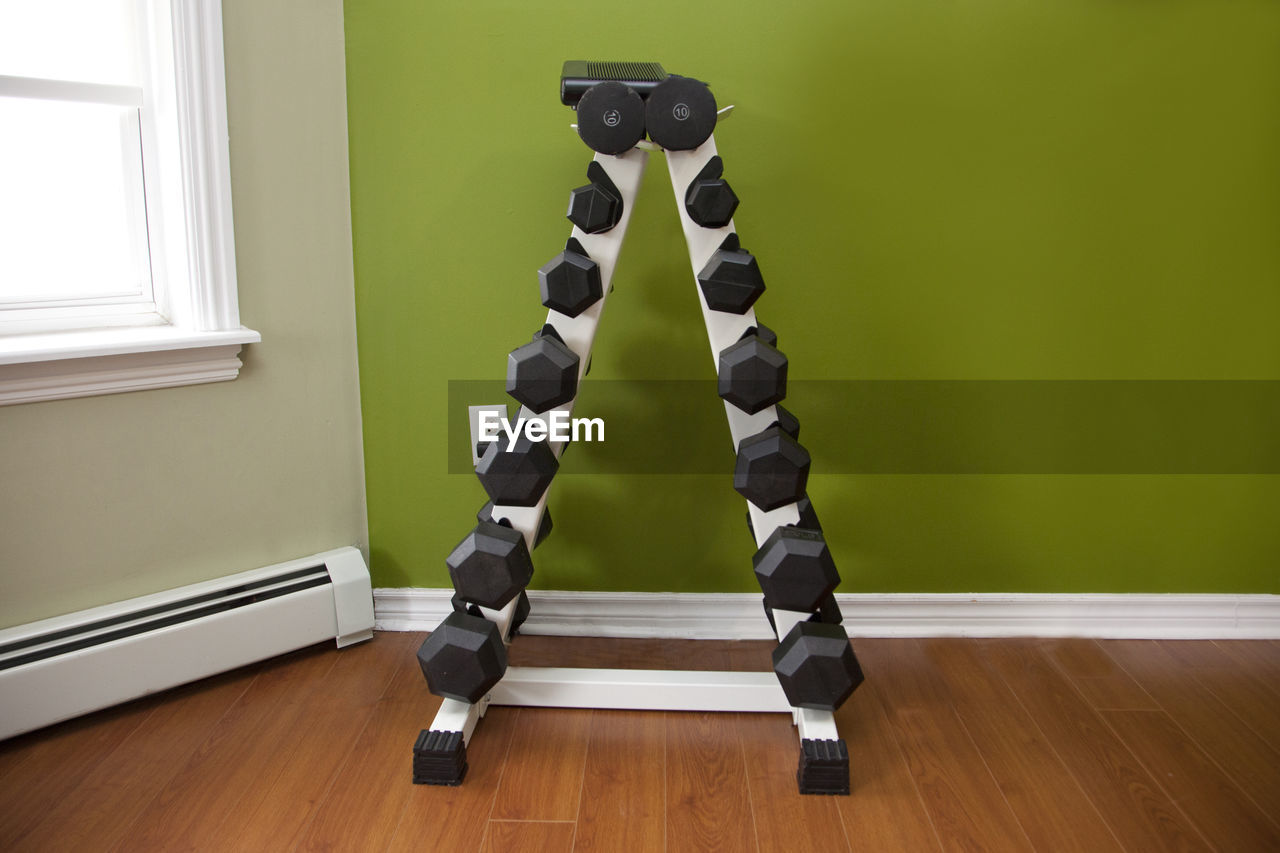 FULL LENGTH OF WOMAN STANDING ON HARDWOOD FLOOR