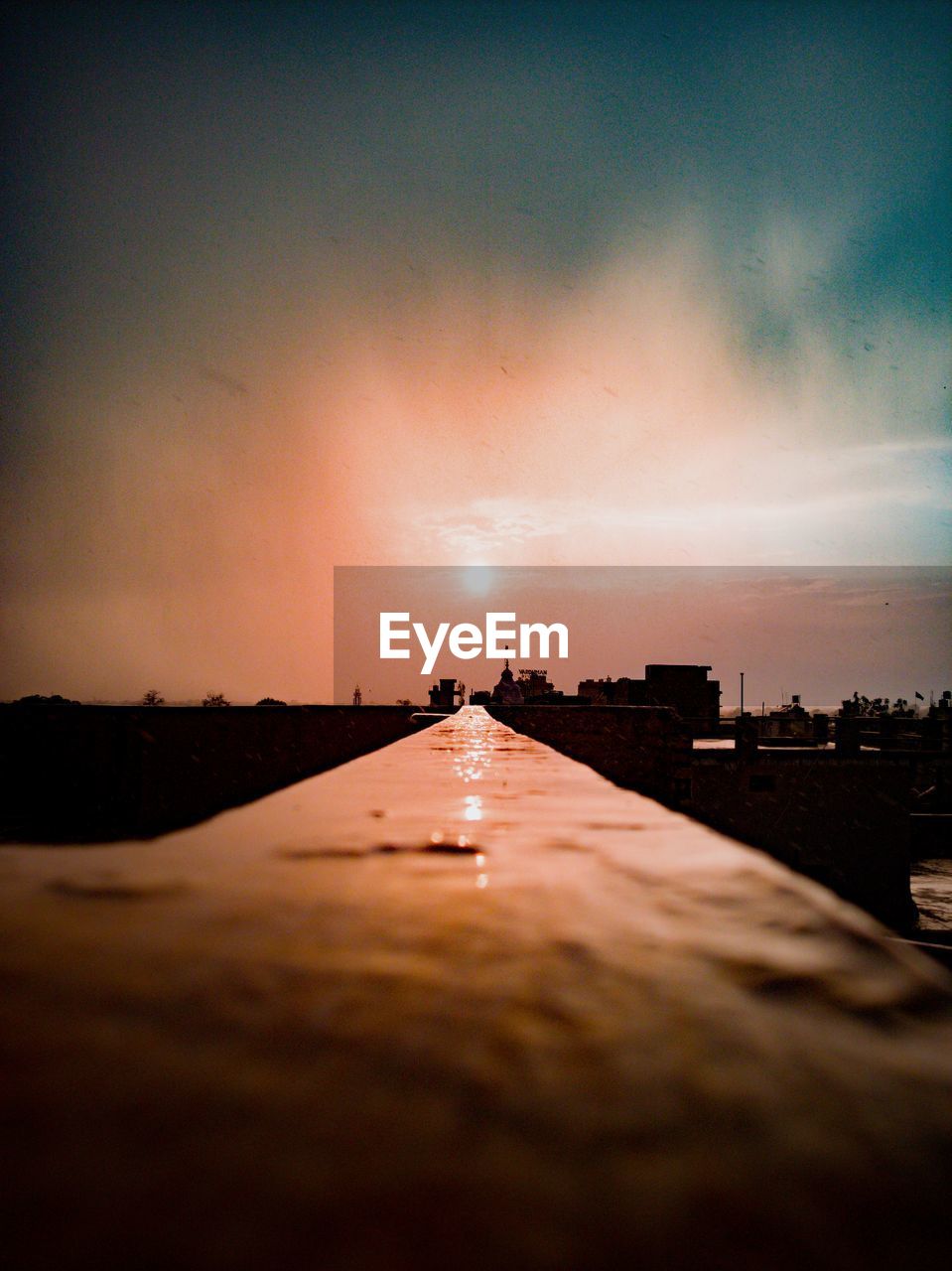 Surface level of water against sky during sunset