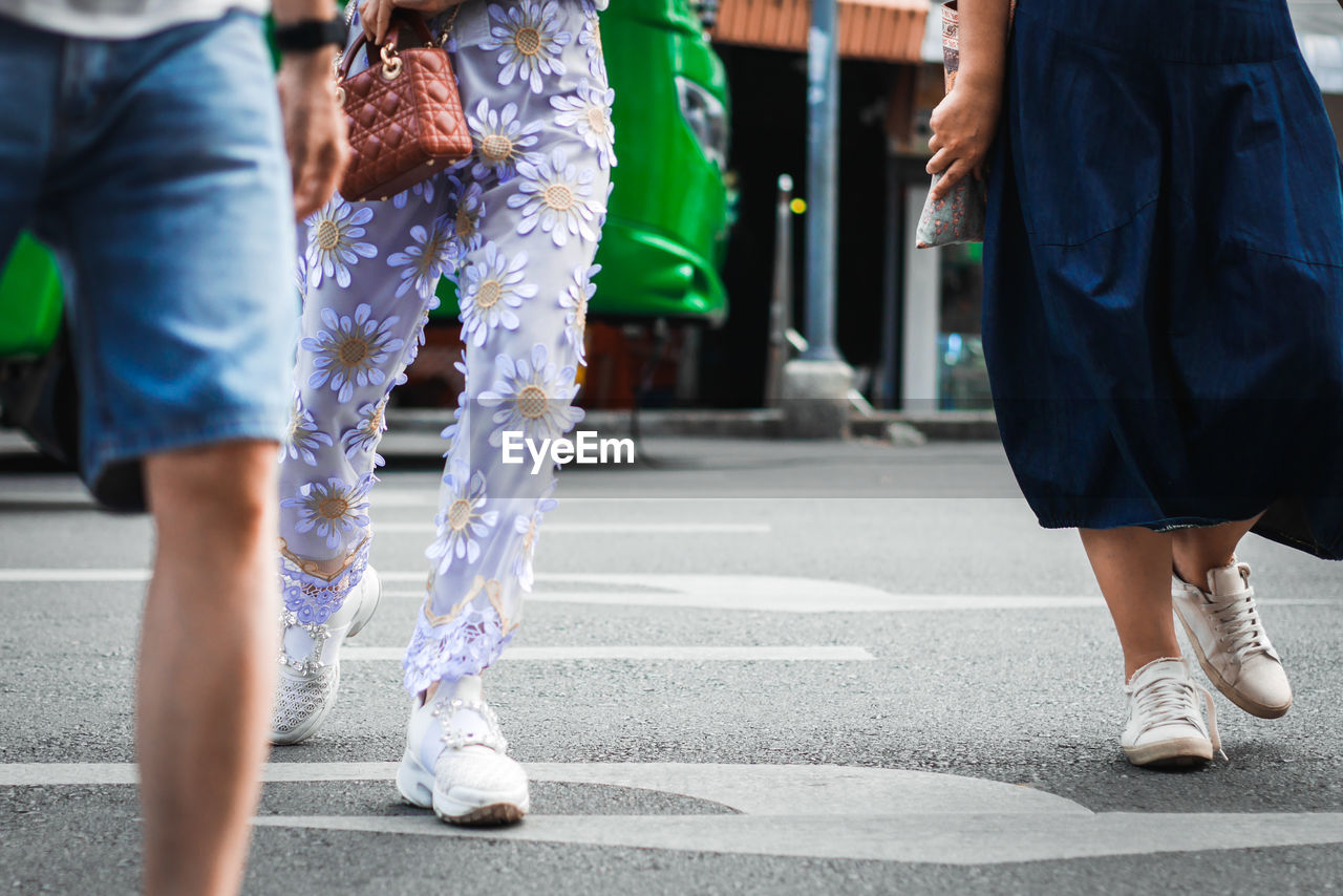 LOW SECTION OF WOMEN WALKING ON ROAD